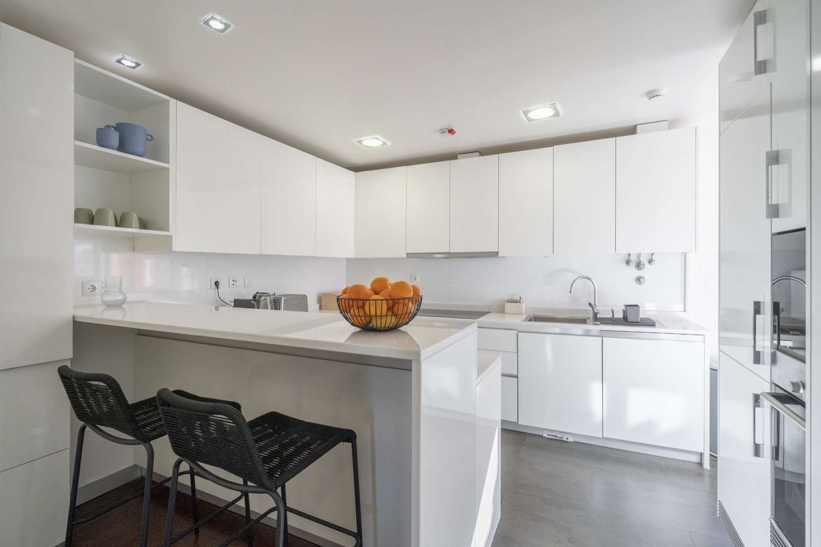 Fully equipped white kitchen with breakfast bar